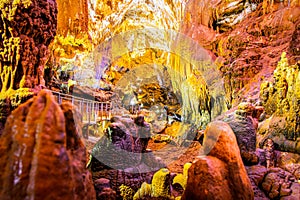 Beautiful Prometheus cave with no tourists and illuminated geological million years formations