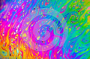 Beautiful psychedelic abstraction formed by light on the surface of a soap bubble