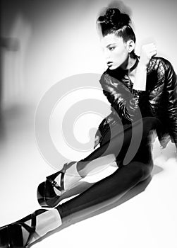 Beautiful punk woman model posing in leather jacket