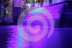 Beautiful purple illuminated fountain at night in Dubai