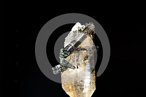 Beautiful Quartz Crystal cluster with tourmaline gemstone isolated on black background