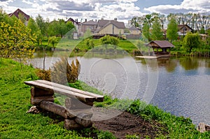 Beautiful quiet lake with a wooden gazebo in a rural cottage village. Country holiday. Pleasant weekend in nature