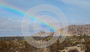 A Beautiful Rainbow Beams Down on the Desert Near the Entrance to Joshua Tree National Park in Southern California