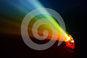 Beautiful rainbow color wide lens projector with light beam for movie and cinema at night . smoke texture spotlight .