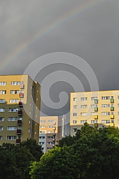 Beautiful rainbow over the city apartment blocks cloudy stormy sky