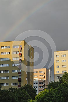 Beautiful rainbow over the city apartment blocks cloudy stormy sky