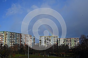 Beautiful rainbow over concrete apartment buildings after rain in Gdansk Zaspa, Poland