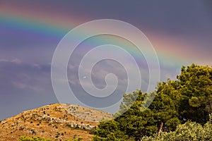 Beautiful rainbow over an island in the Adriatic Sea. Rainbow after a storm at sea