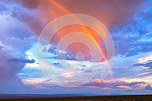 A beautiful rainbow during a sunset after a monsoon storm.