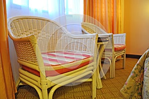 beautiful rattan relax chairs near the window.