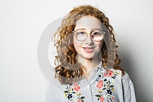 Beautiful readhead girl with on studio white background