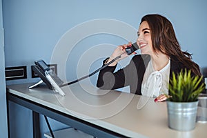 Receptionist girl talking on the phone and smiling