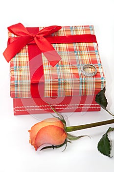 Beautiful red box with red bow, orange rose and engagement ring