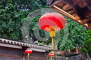 Beautiful red Chinese lantern hanging on eaves of  traditional Chinese old style Chinese wood  building