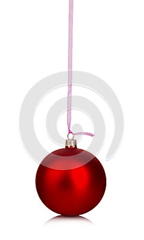 Beautiful red Christmas ball hanging with pink ribbon on a white background.