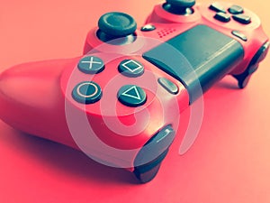 Beautiful red digital modern new game joystick for computer video games gamepad on a red background