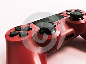 Beautiful red digital modern new game joystick for computer video games gamepad on a pink background