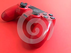 Beautiful red digital modern new game joystick for computer video games gamepad on a red background