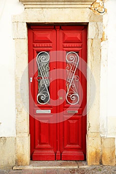 Beautiful red door of house in Faro, Algarve, South of Portugal