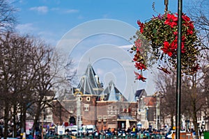 Beautiful red flowers embellish the bridges at the Old Central district in Amsterdam