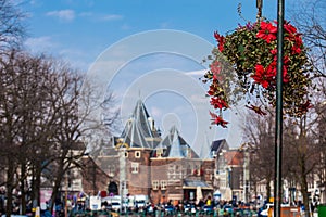 Beautiful red flowers embellish the bridges at the Old Central district in Amsterdam photo