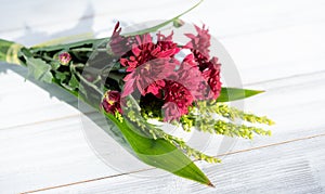 Beautiful red fresh chrysanthemum flowers boquet on white wooden