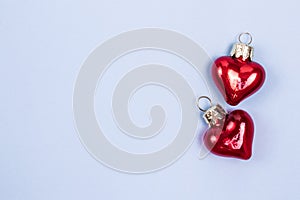 Beautiful red glass hearts with reflects on pastel blue background. Copy space. Valentines Day Concept