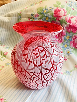 Beautiful Red Glass Vase with White Foam Crackle Overlay on Floral Background