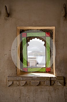 Beautiful red and gren stained glass window in the ancient city palace in Udaipur, India