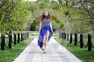 Beautiful red hair girl in a blue dress