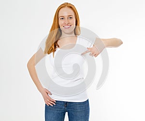 Beautiful red hair girl pointed on a white t-shirt isolated. Pretty smile red head woman in tshirt mock up, blank