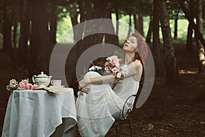 Beautiful red hair woman in a forest