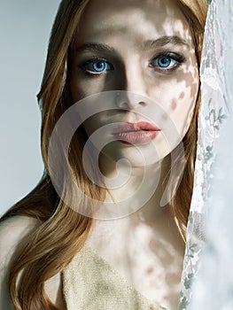 Beautiful red hair Woman. Sweet Girl in daylight from a window