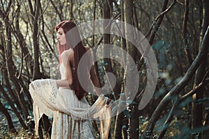 Beautiful red hair woman in the woods