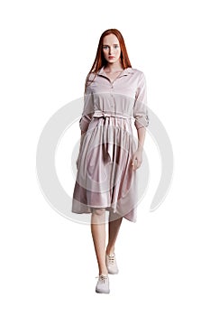 Beautiful red hair women model in pink cotton dress with belt