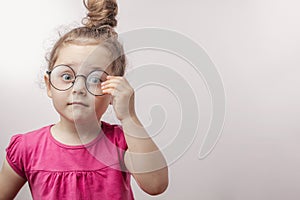 Beautiful red-haired girl touching her eyewear