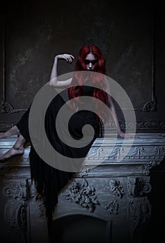 Beautiful red haired woman in black dress