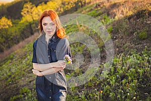 Beautiful red haired woman holding bouquet