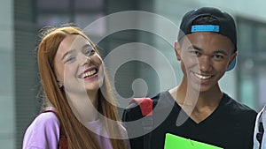 Beautiful red-head teen and mixed race male students smiling on camera education