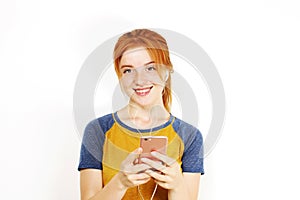 Beautiful red headed young woman posing, showing emotional facial expressions and making funny faces with mobile phone