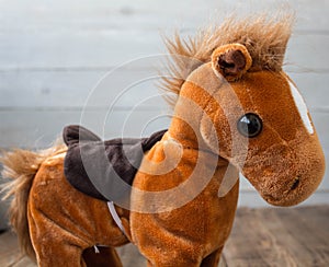 A beautiful red horse with a saddle kid toy