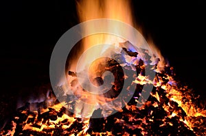 Beautiful red hot glowing ember pile with colorful flames