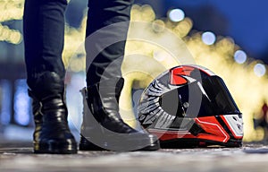 Beautiful red motorcycle helmet with black visor. Lies on a bright garland