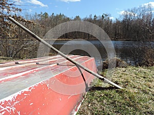 Beautiful red old red boat beside pond