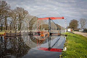 Beautiful red painted drawbridge with a nice water reflection