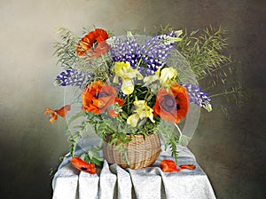 Beautiful red poppies,lupines,irises in a vase,isolated on a blue background