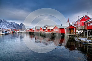 Beautiful red rorbu in overcast day. Fishing village