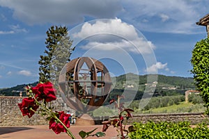 Beautiful red roses near Uomo di Vinci in the historic center of Vinci, Florence, Italy, on a sunny day photo