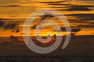 beautiful red sunset over the ocean. Bright sunset with large yellow sun under the sea surface. sundown seascape