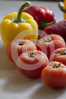 Beautiful red tomatoes on the kitchen counter with other vegetables
